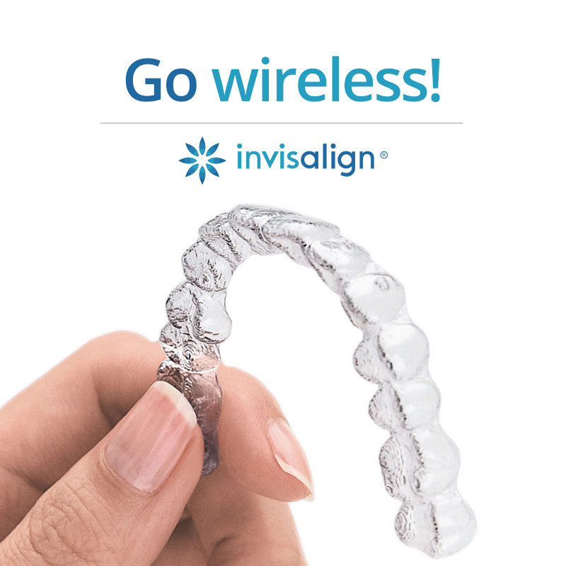 A clear Invisalign aligner held between two fingers